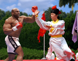 Sun Chang (right) fights Ebony Avalanche for Rumsfeld's amusement.